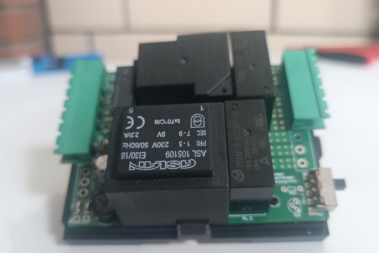 önde beyaz fon üzerinde TNS Otel enerji rölesi ve arka planda buğulu yankeski olan ürün görseli